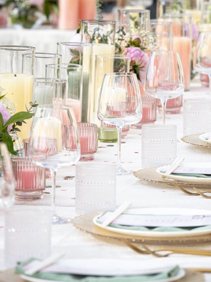 A table set with gold chargers and candles